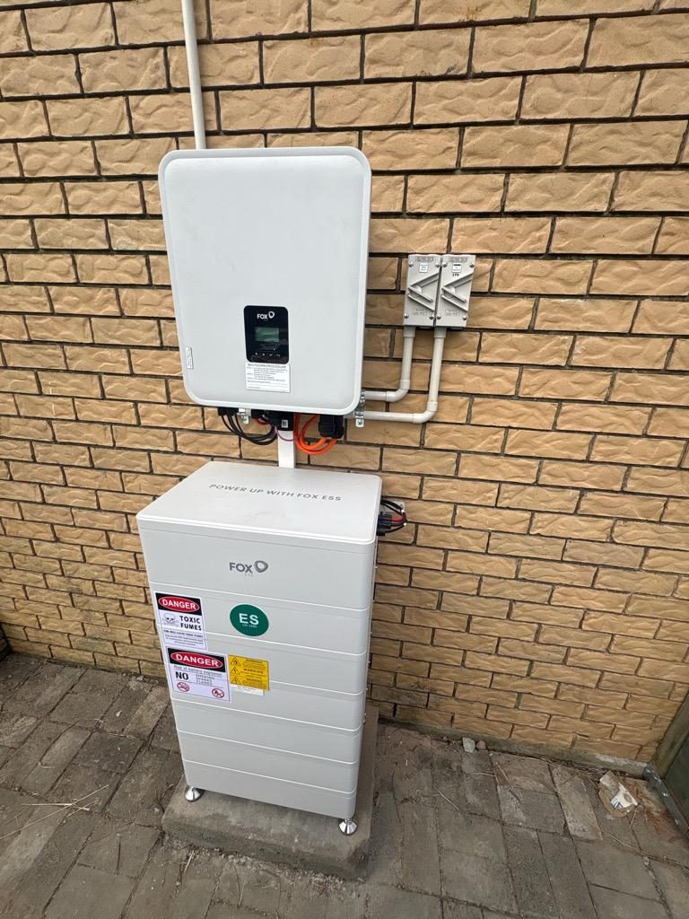 Fox ESS inverter and battery system installed on a brick exterior wall